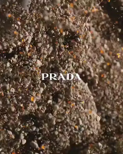 A Prada title treatment rendered in sand